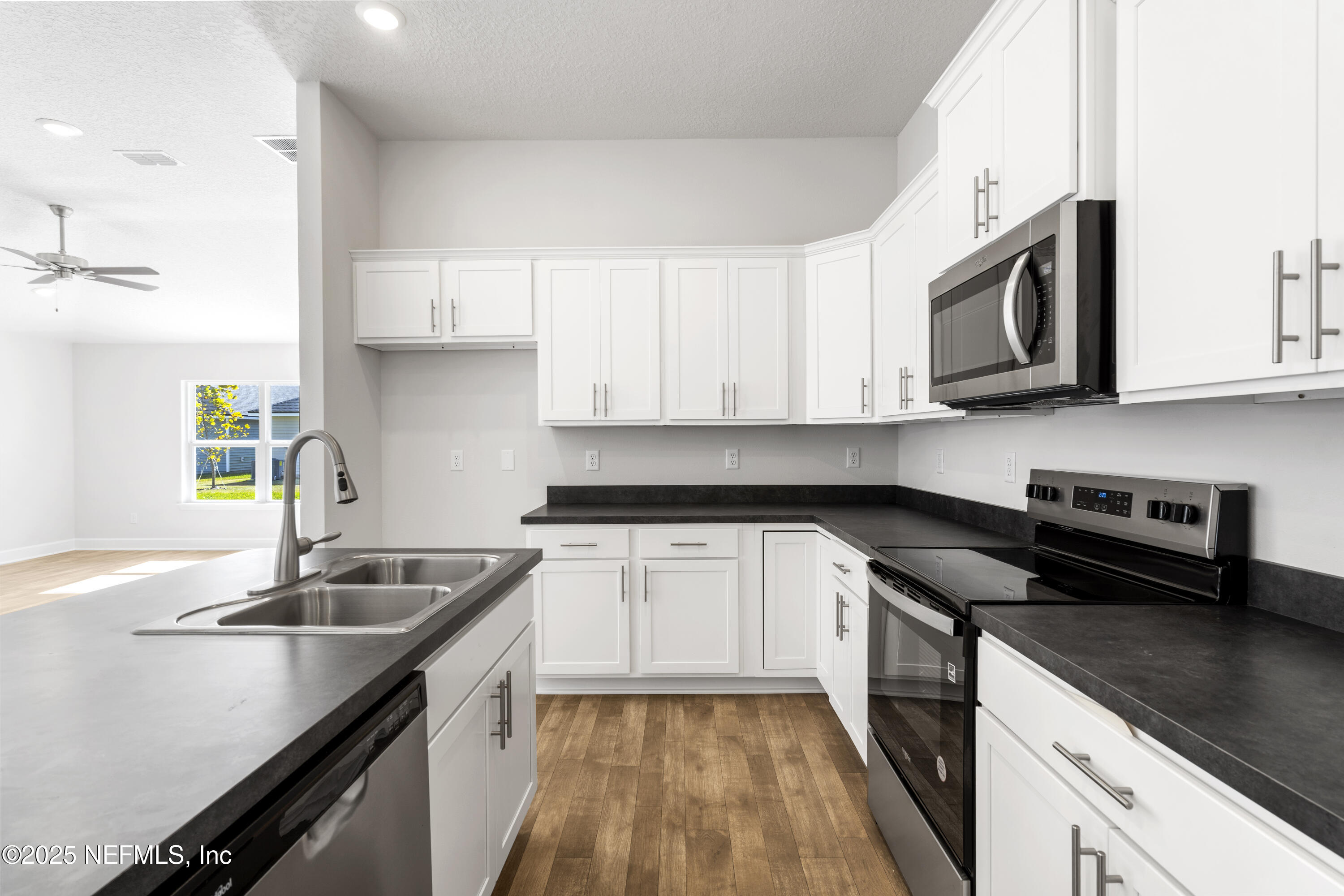 8340 Helmsley Boulevard Jacksonville, FL 32219 - Photo 50 of 56 a kitchen with stainless steel appliances granite countertop a sink stove and microwave