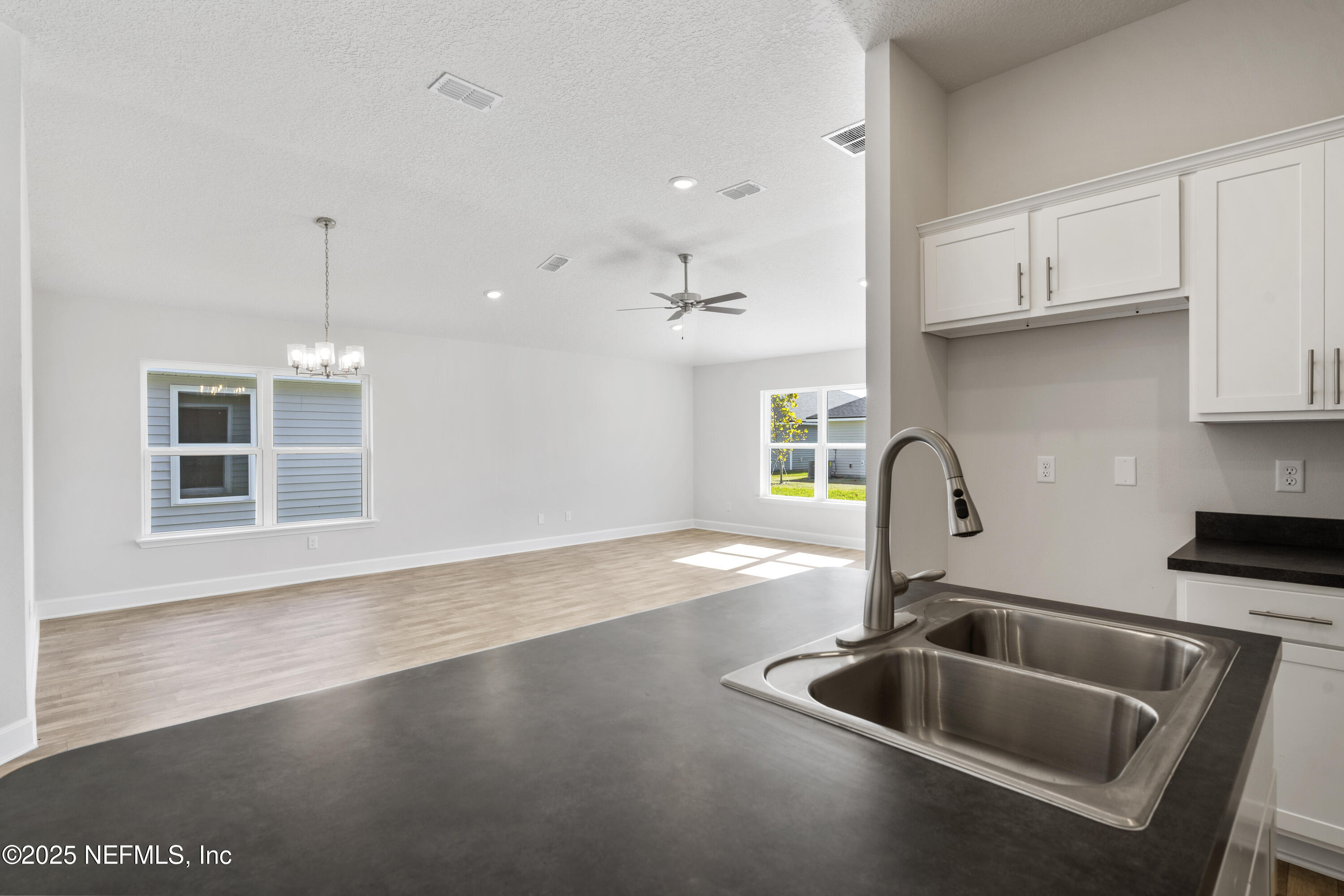 8340 Helmsley Boulevard Jacksonville, FL 32219 - Photo 51 of 56 a kitchen with a sink and a stove top oven