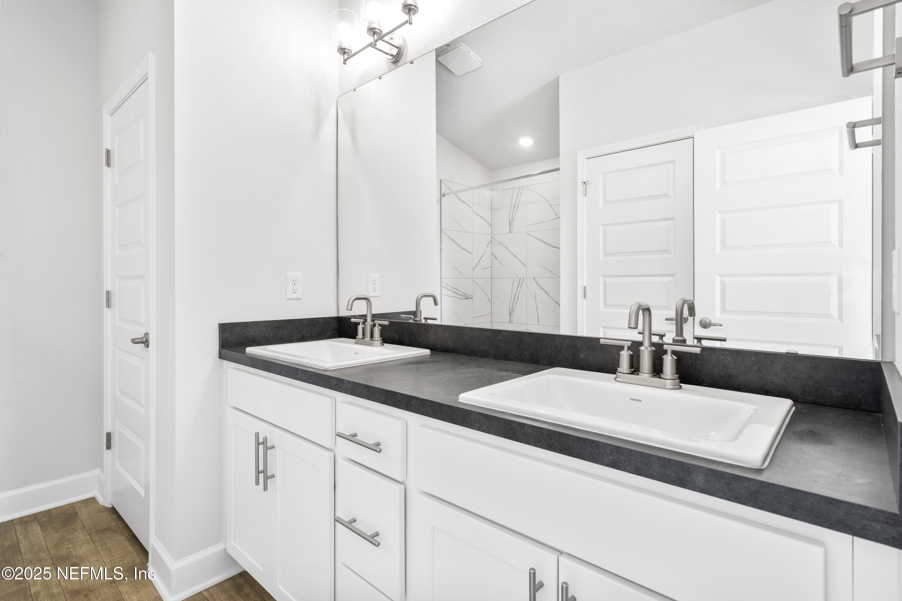 8340 Helmsley Boulevard Jacksonville, FL 32219 - Photo 54 of 56 a bathroom with a sink and a mirror