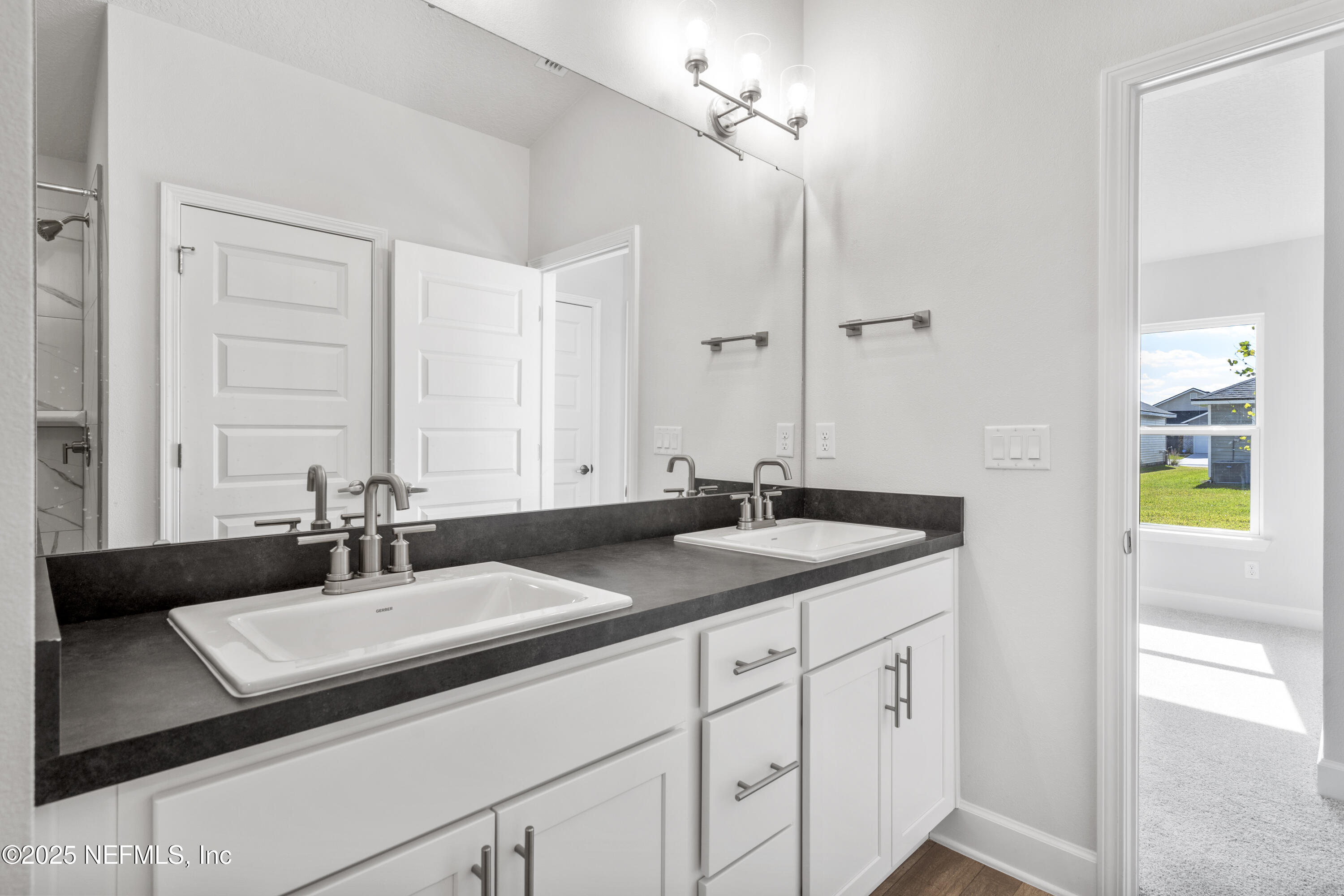 8340 Helmsley Boulevard Jacksonville, FL 32219 - Photo 56 of 56 a bathroom with a sink and a mirror