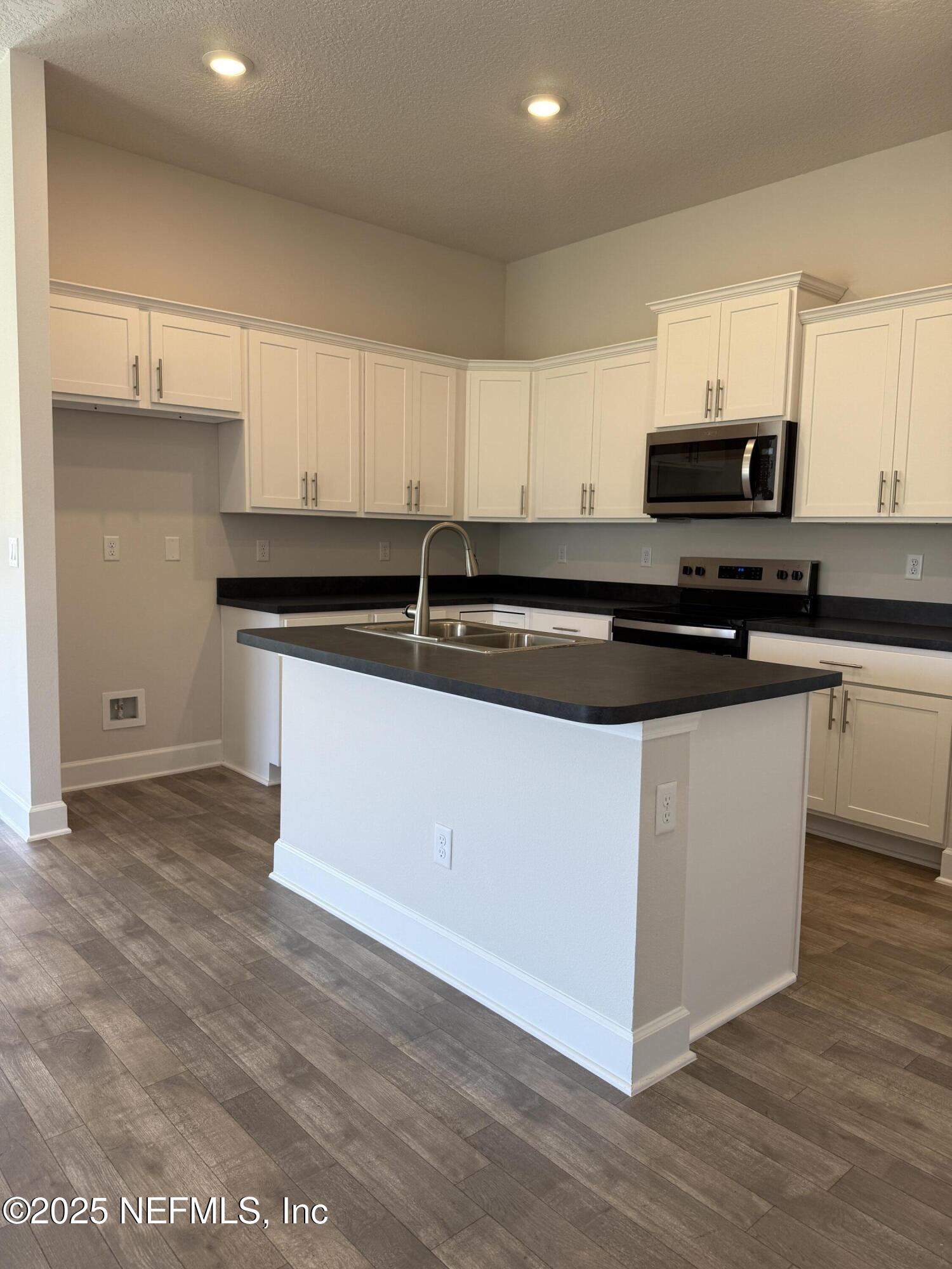 8340 Helmsley Boulevard Jacksonville, FL 32219 - Photo 6 of 56 a kitchen with granite countertop a sink and cabinets