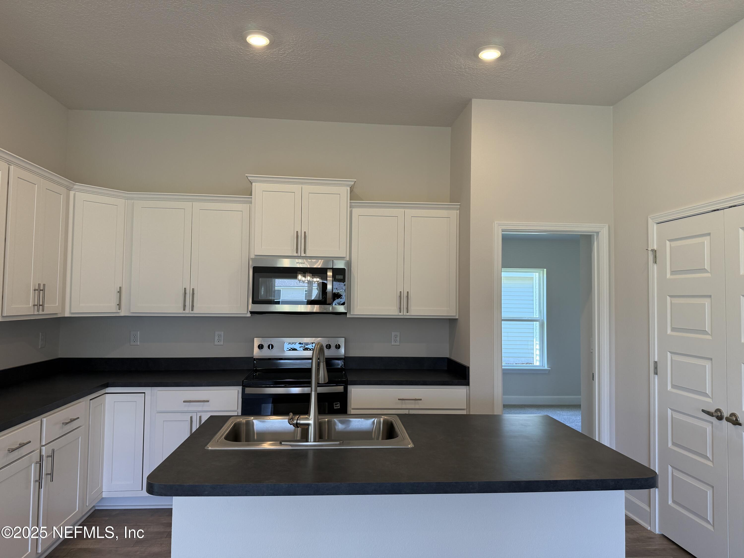 8340 Helmsley Boulevard Jacksonville, FL 32219 - Photo 8 of 56 a kitchen with stainless steel appliances granite countertop a sink a stove and a refrigerator