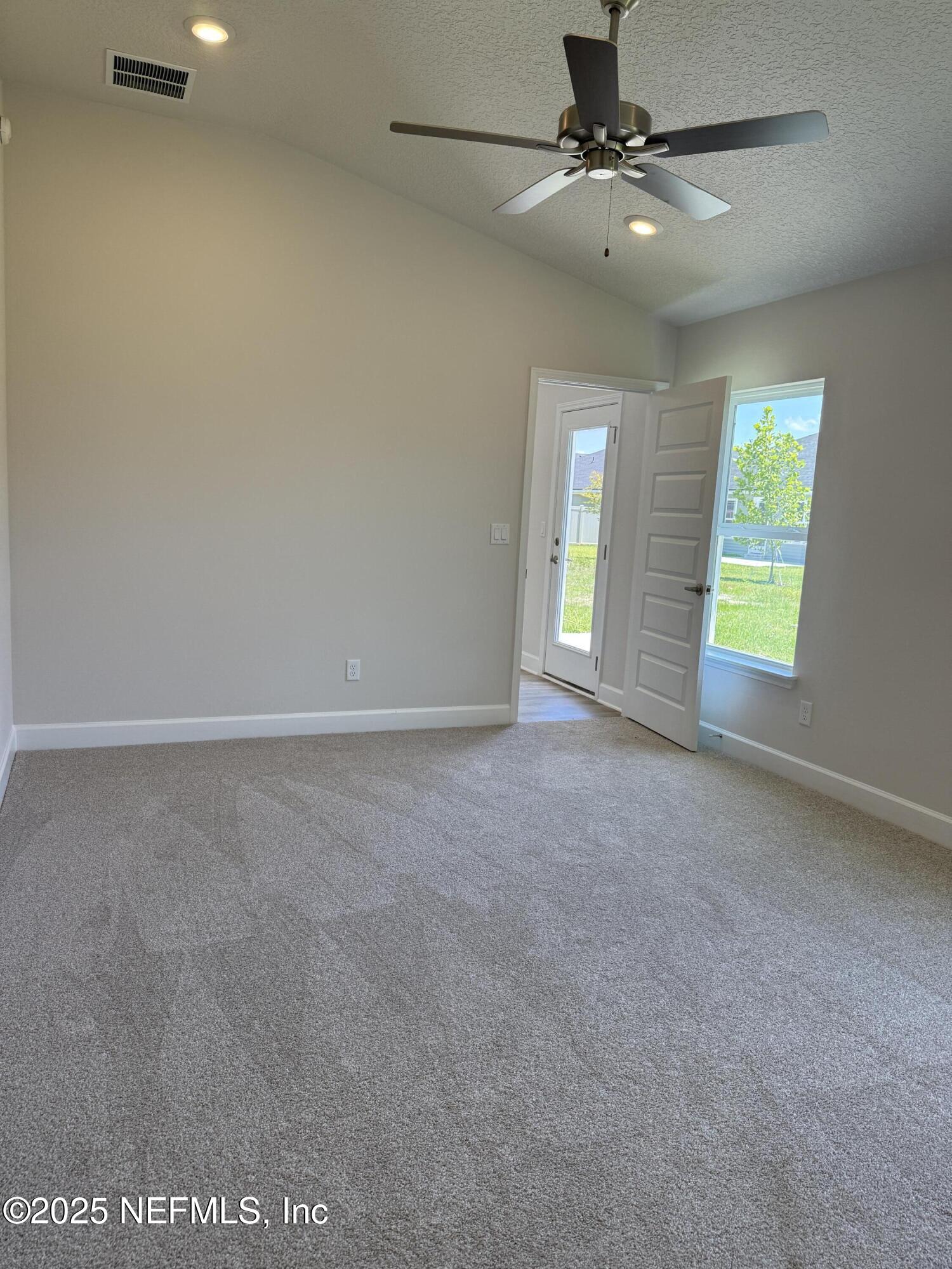 8340 Helmsley Boulevard Jacksonville, FL 32219 - Photo 10 of 56 an empty room with windows and fan