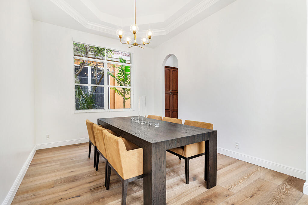 317 Galicia Way Jupiter, FL 33458 - Photo 18 of 31 a view of a dining room with furniture window and wooden floor
