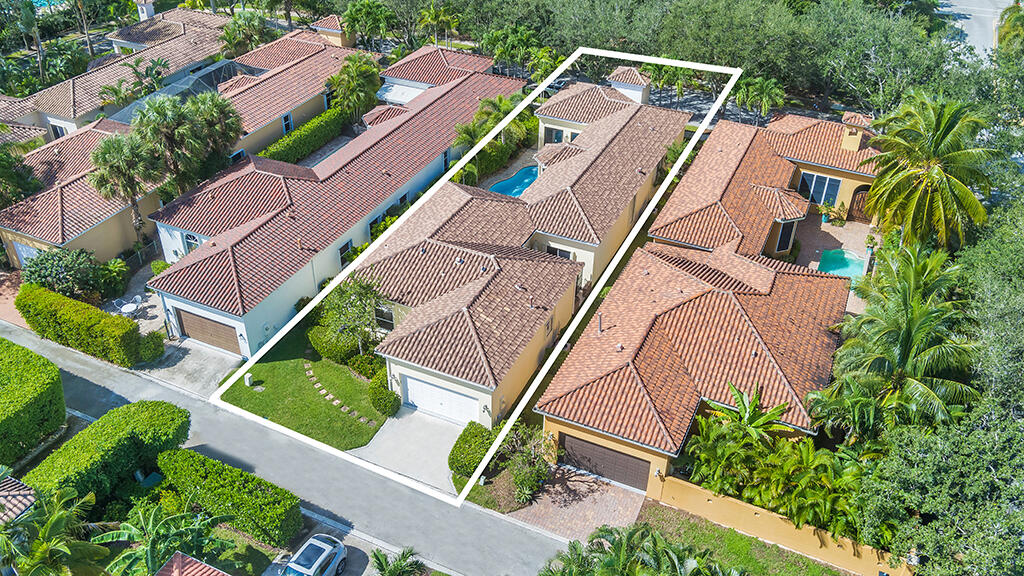 317 Galicia Way Jupiter, FL 33458 - Photo 2 of 31 an aerial view of multiple houses with yard