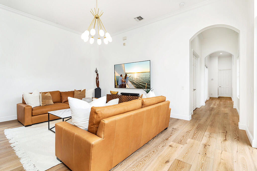 317 Galicia Way Jupiter, FL 33458 - Photo 22 of 31 a living room with furniture and a chandelier