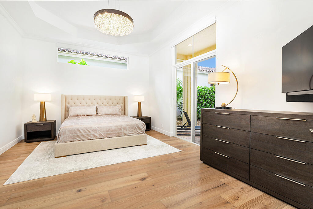 317 Galicia Way Jupiter, FL 33458 - Photo 23 of 31 a bedroom with a bed and a dresser