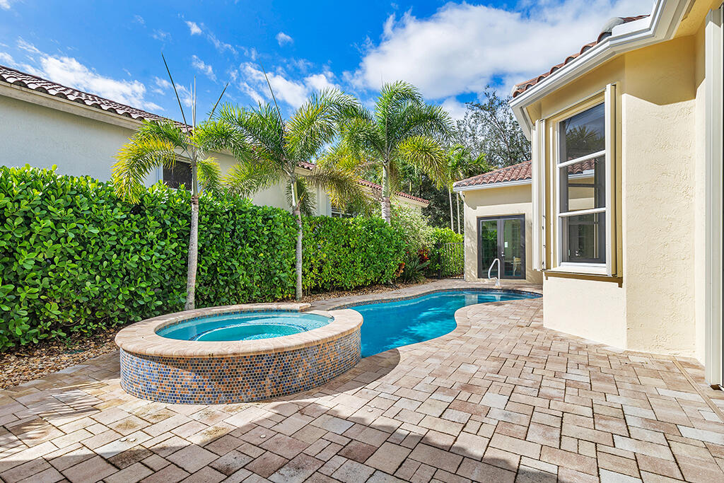 317 Galicia Way Jupiter, FL 33458 - Photo 26 of 31 a view of a swimming pool with a patio