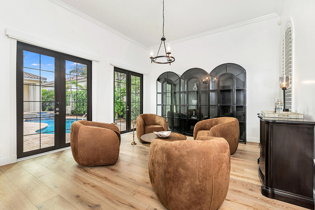 317 Galicia Way Jupiter, FL 33458 - Photo 4 of 31 a living room with couches a large mirror with wooden floor