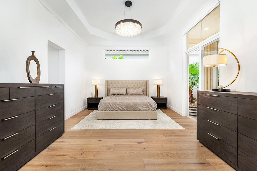 317 Galicia Way Jupiter, FL 33458 - Photo 5 of 31 a bedroom with a bed and a dresser