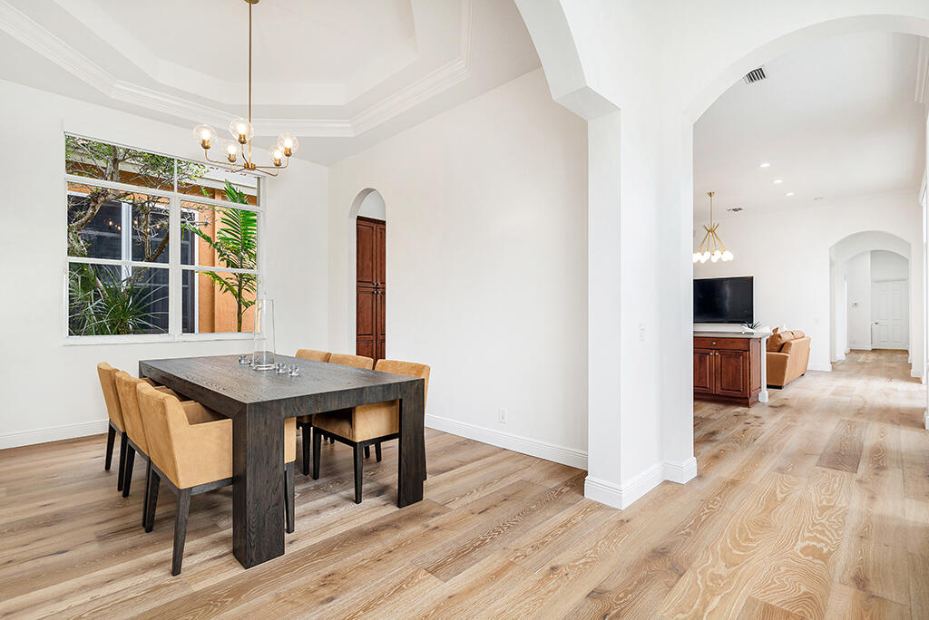 317 Galicia Way Jupiter, FL 33458 - Photo 10 of 31 a view of a dining room with furniture window and wooden floor