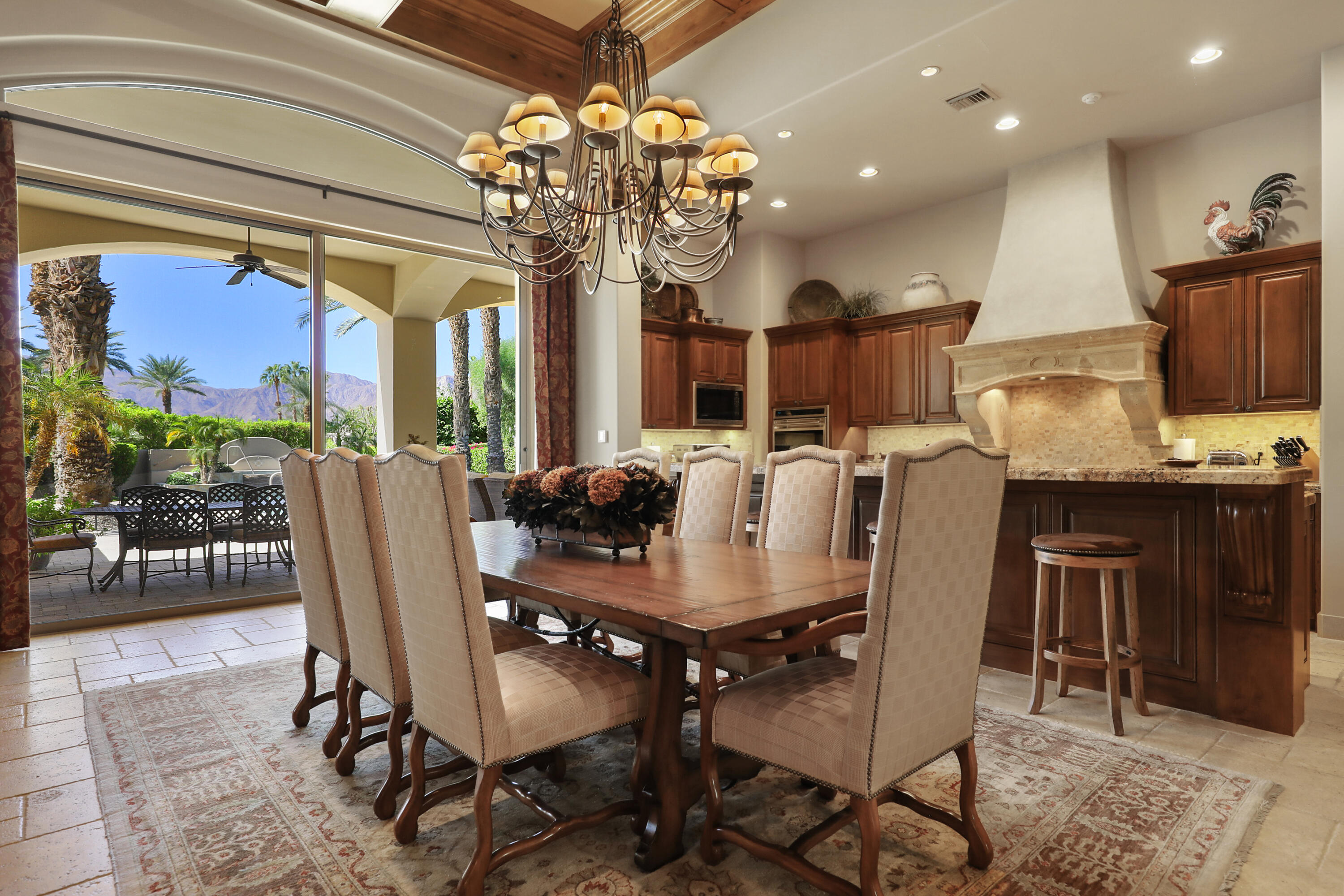 50360 Woodmere La Quinta, CA 92253 - Photo 18 of 56 a view of a dining room with furniture a chandelier and wooden floor