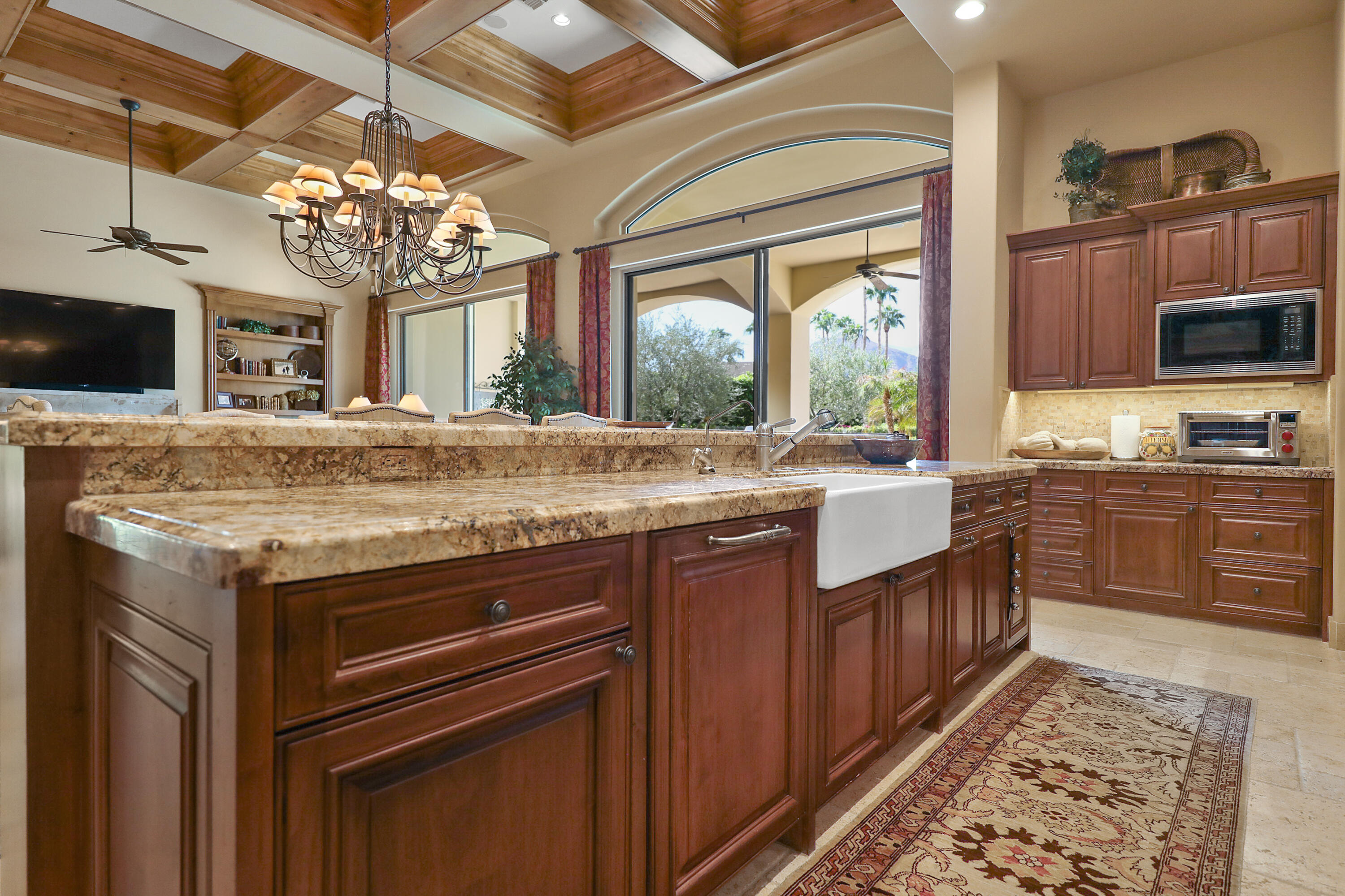 50360 Woodmere La Quinta, CA 92253 - Photo 19 of 56 a kitchen with granite countertop a sink stainless steel appliances wooden floor and cabinets