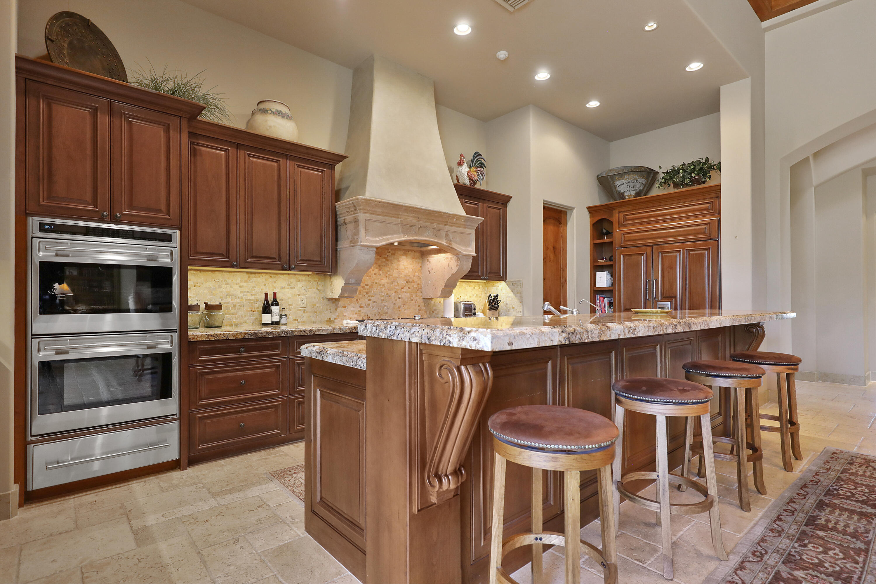 50360 Woodmere La Quinta, CA 92253 - Photo 21 of 56 a kitchen with a table chairs microwave and cabinets