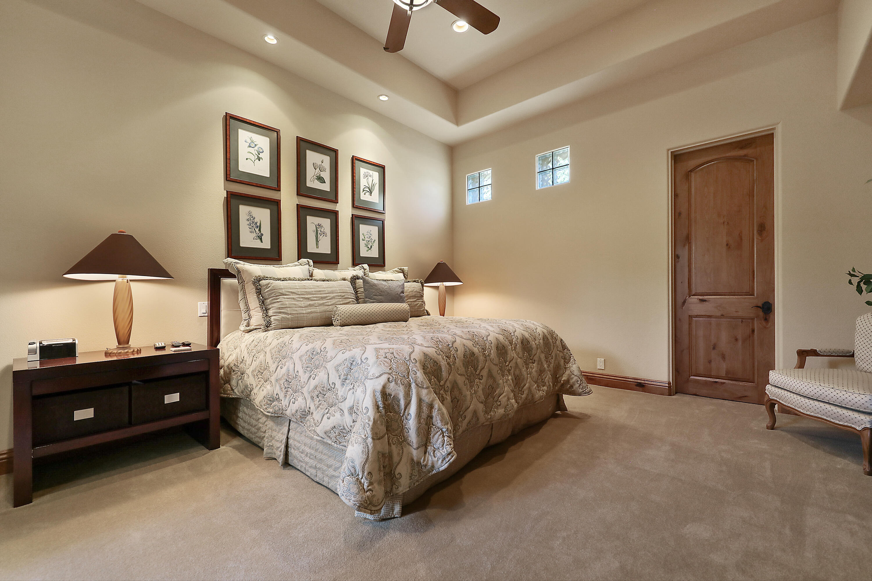 50360 Woodmere La Quinta, CA 92253 - Photo 29 of 56 a spacious bedroom with a bed and a lamp on dresser