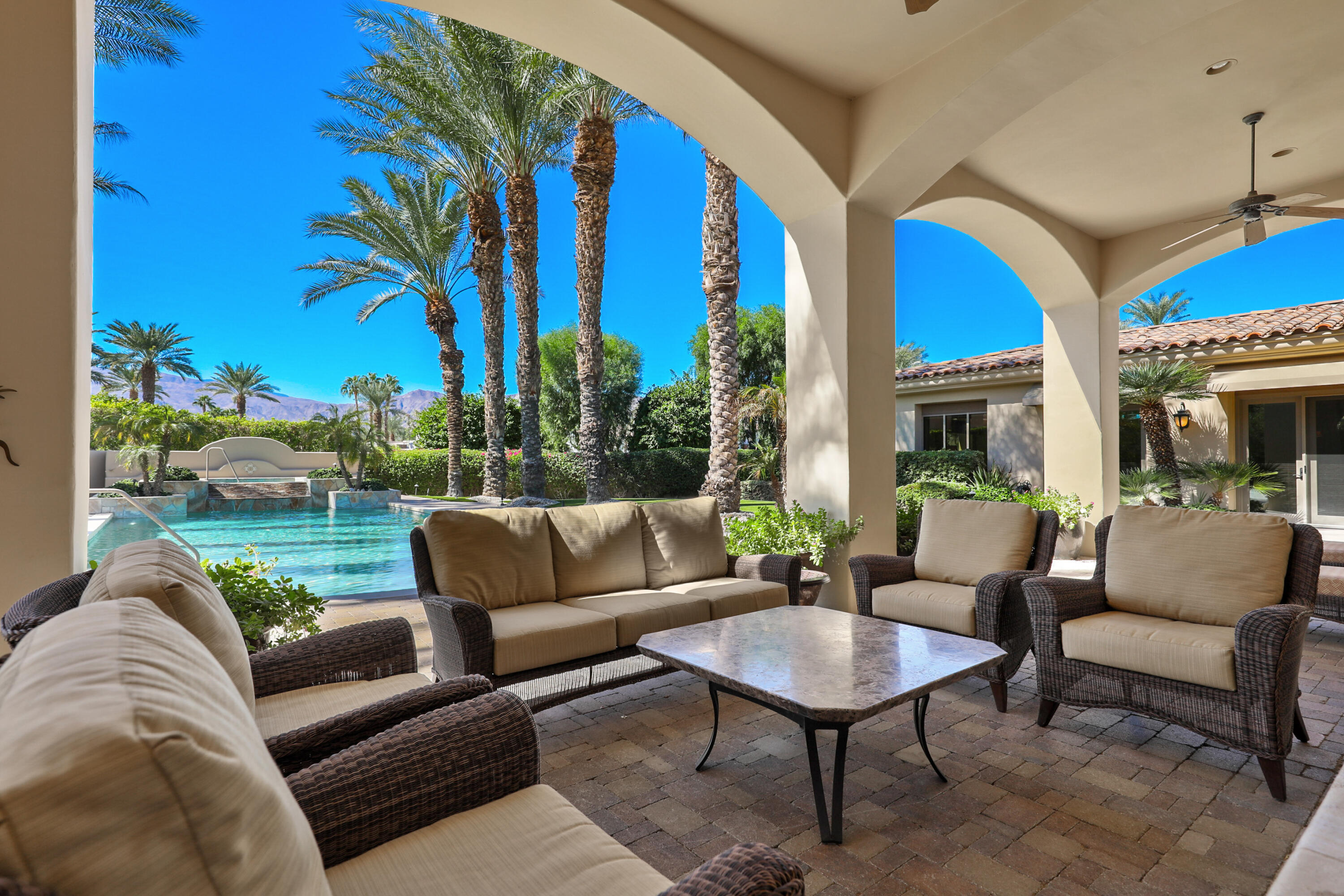 50360 Woodmere La Quinta, CA 92253 - Photo 40 of 56 a view of a patio with couches and a table and chairs with garden view