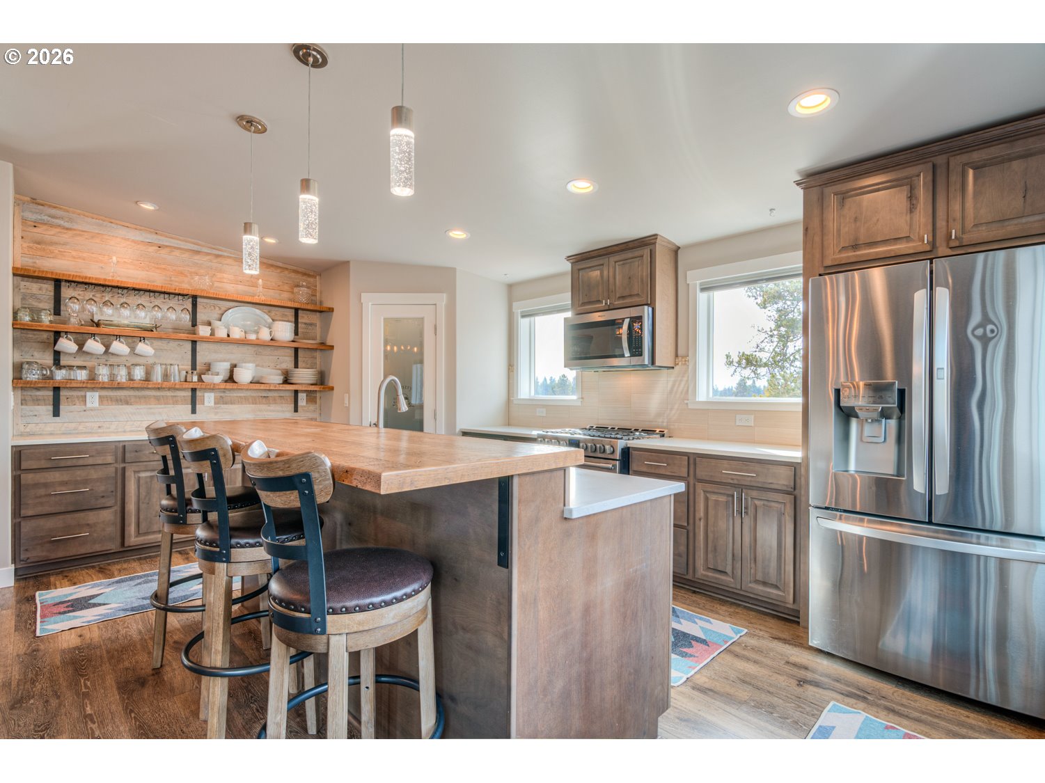 16732 Contorta Place La Pine, OR 97739 - Photo 35 of 48 a kitchen with stainless steel appliances kitchen island granite countertop a table chairs and a refrigerator