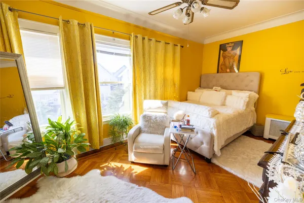 a bedroom with a bed couch and a potted plant