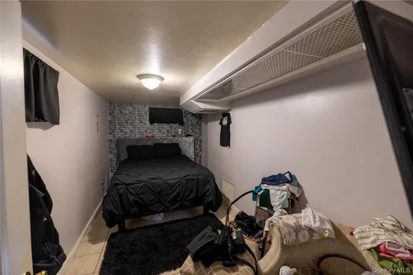 a bedroom with a bed and a television