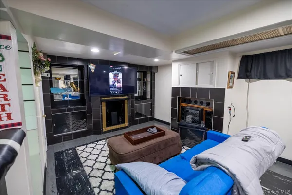 a living room with furniture a flat screen tv and a fireplace