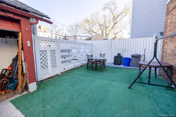 a view of backyard with table and chairs