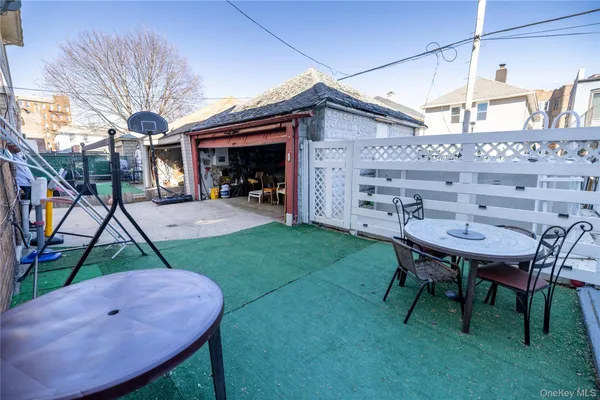 a backyard of a house with table and chairs