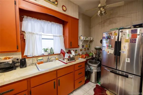 a kitchen with refrigerator and cabinets