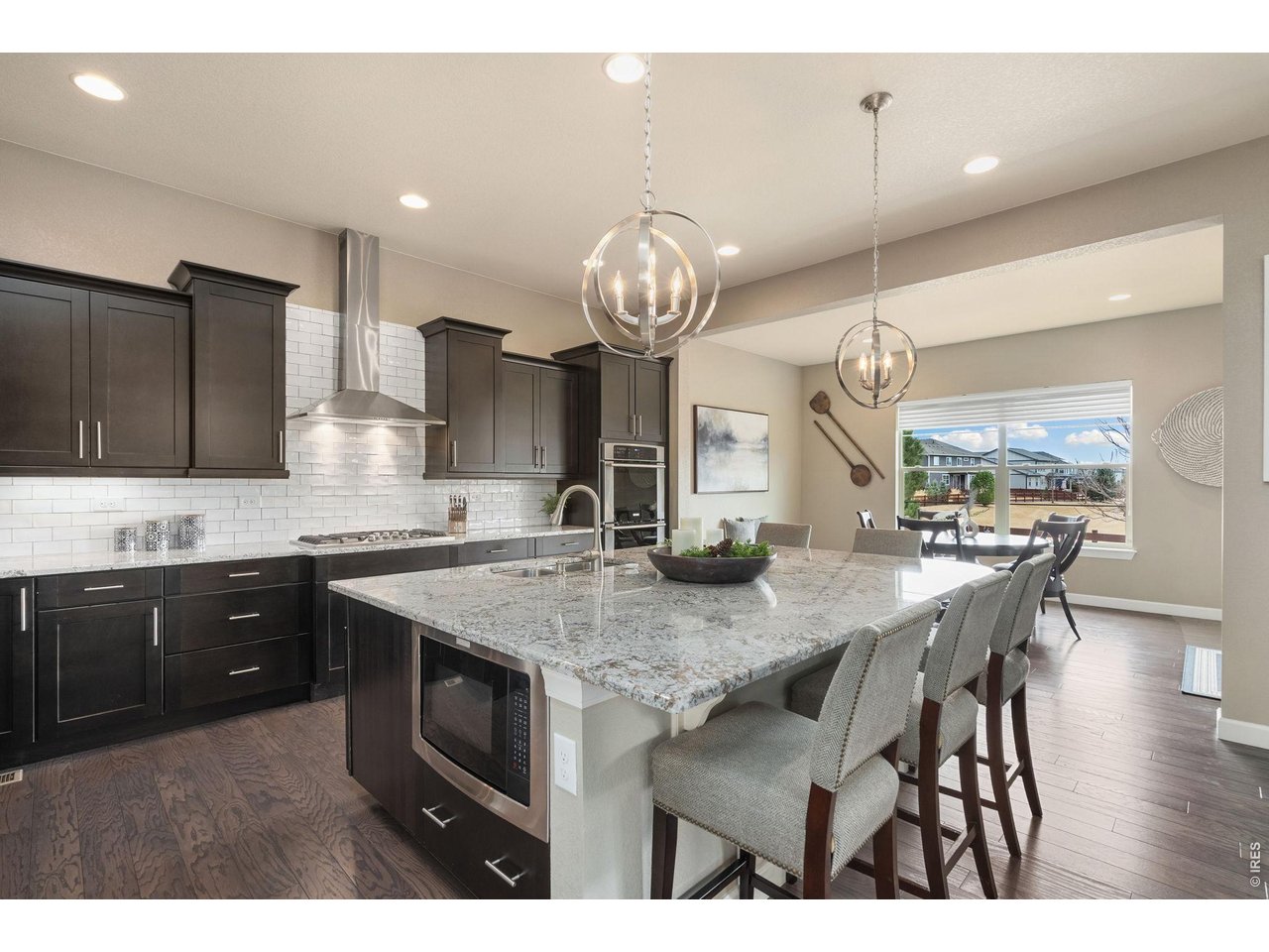 5879 Story Road Timnath, CO 80547 - Photo 11 of 49 Kitchen offers abundant cabinetry and information seating at the large granite island