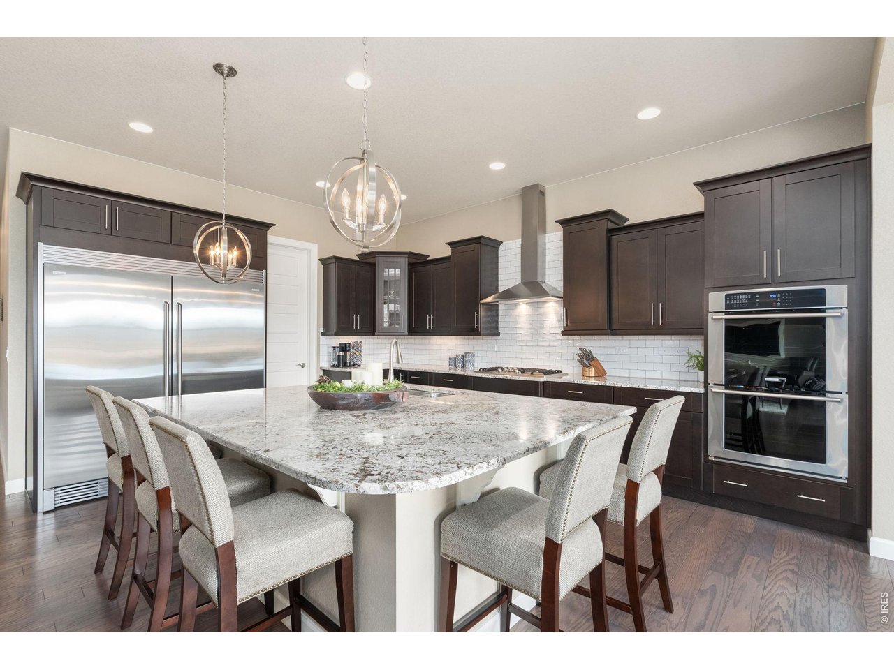 5879 Story Road Timnath, CO 80547 - Photo 13 of 49 Electrolux appliances with built in refrigerator and freezer, double ovens, gas cooktop and microwave