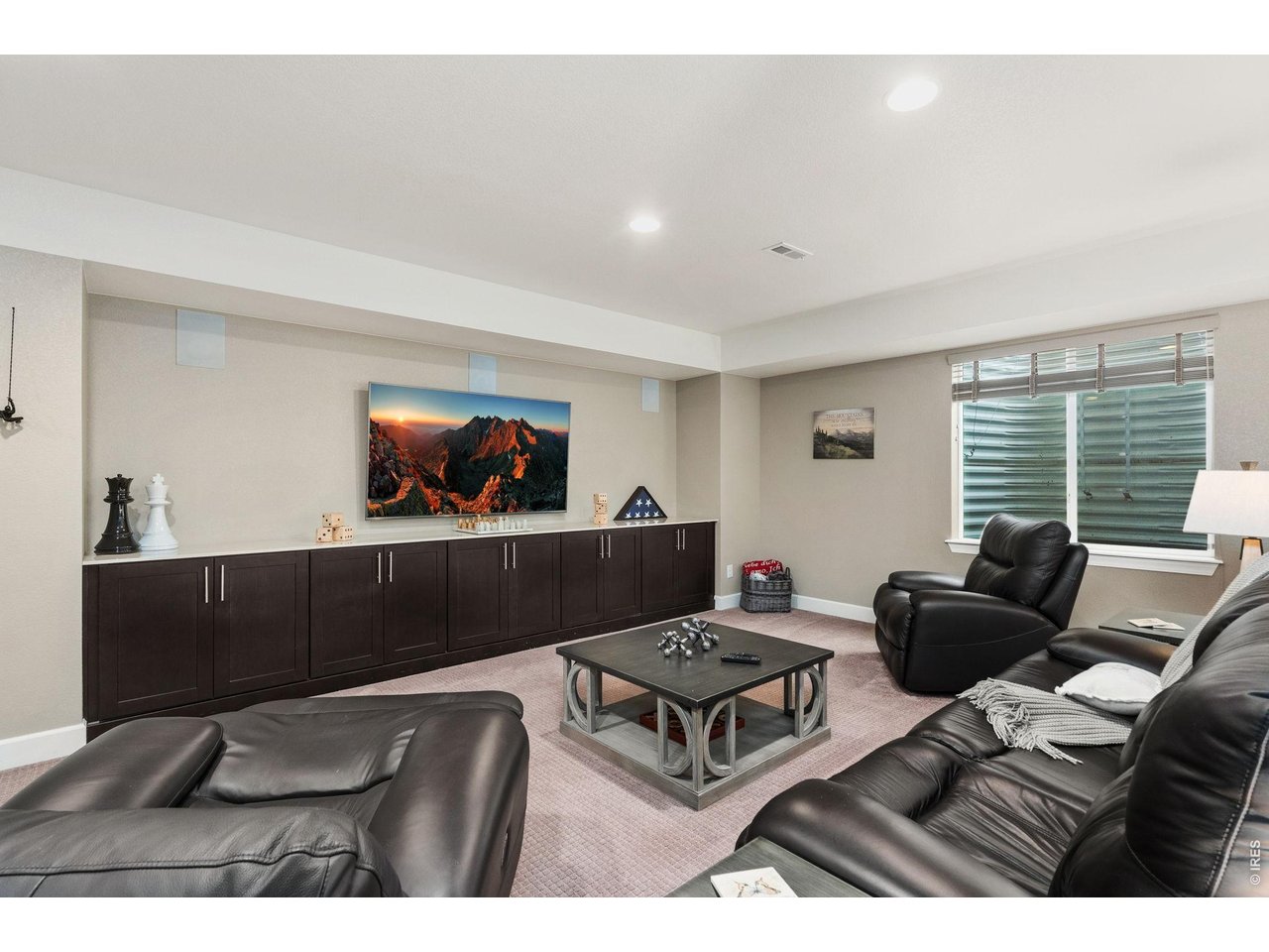 5879 Story Road Timnath, CO 80547 - Photo 30 of 49 Lower level rec room with 18' cabinetry and quartz counter top is perfect for storage for games and toys