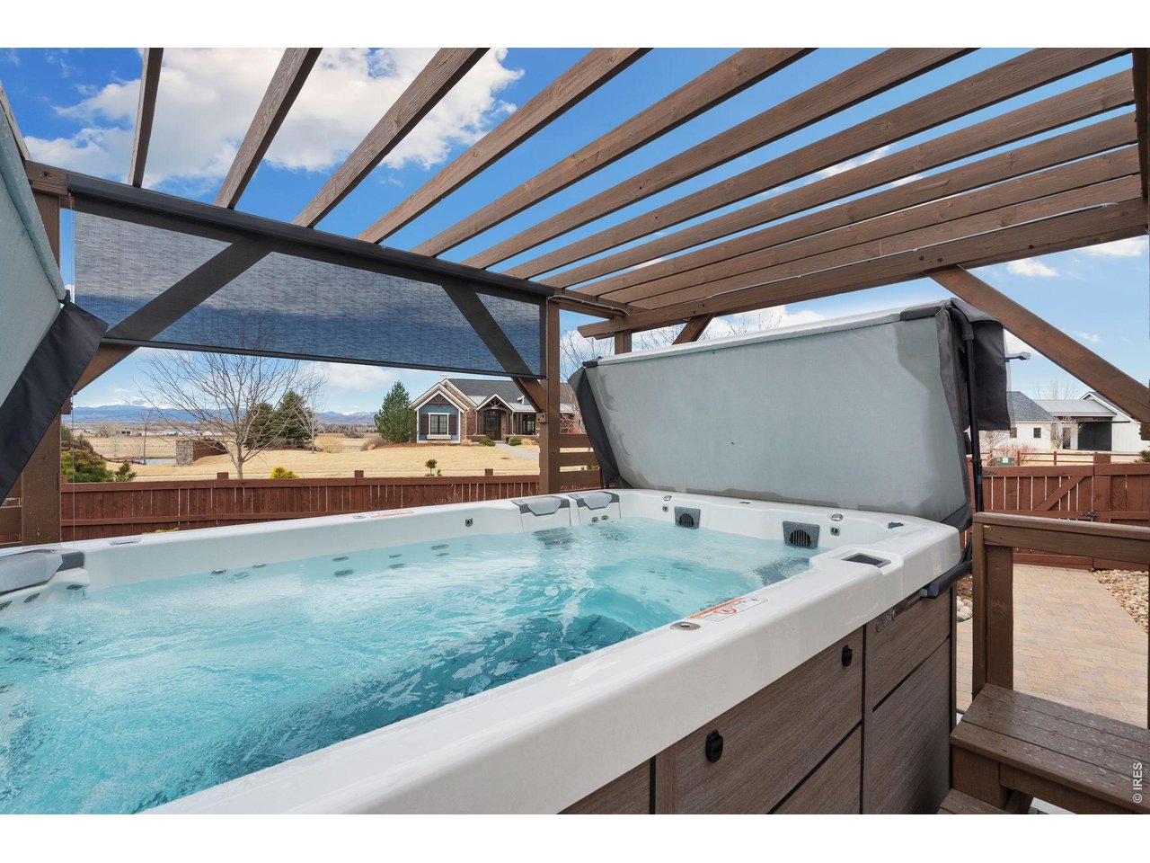 5879 Story Road Timnath, CO 80547 - Photo 42 of 49 Swim spa with pergola offers a mountain view - a great place to workout or just relax!