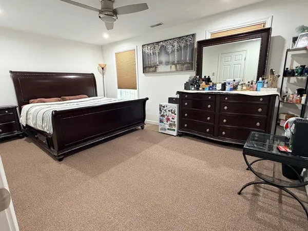 a bedroom with a bed and window