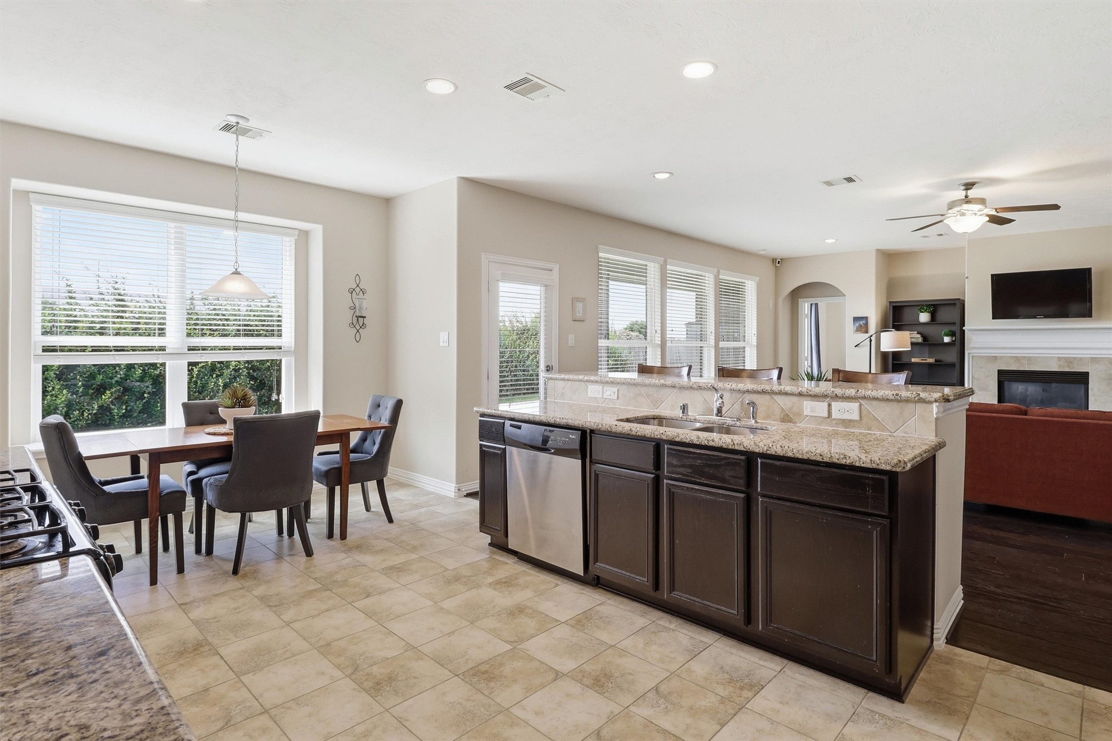 3219 Cotton Ranch Drive Katy, TX 77494 - Photo 14 of 45 The breakfast area enjoys peaceful backyard views through oversized windows and easy access to the covered patio for seamless indoor-outdoor living.