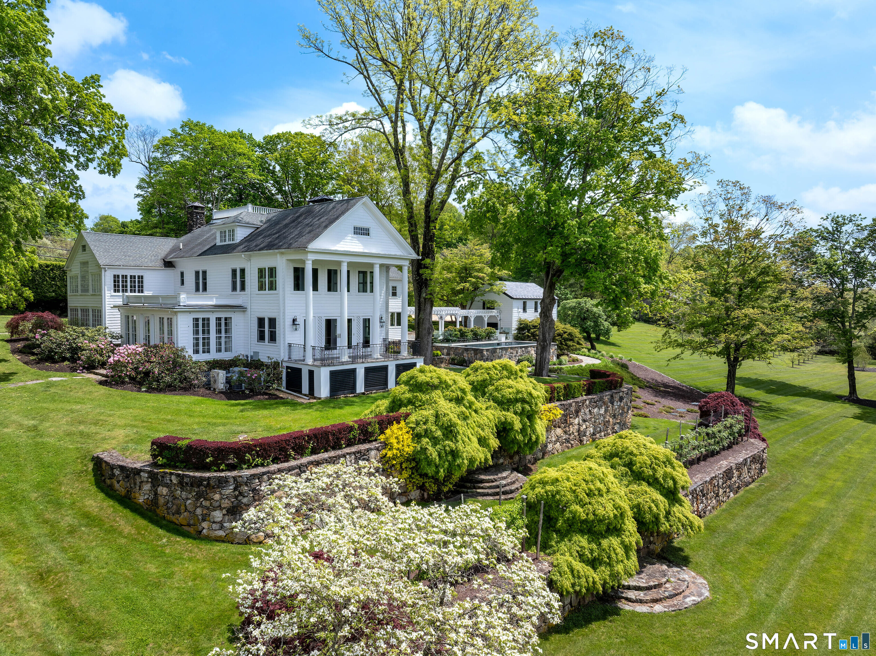 155 Long Ridge Road Danbury, CT 06810 - Photo 2 of 40 From this angle, the scale of the main house and its relationship to the surrounding landscape become fully apparent.