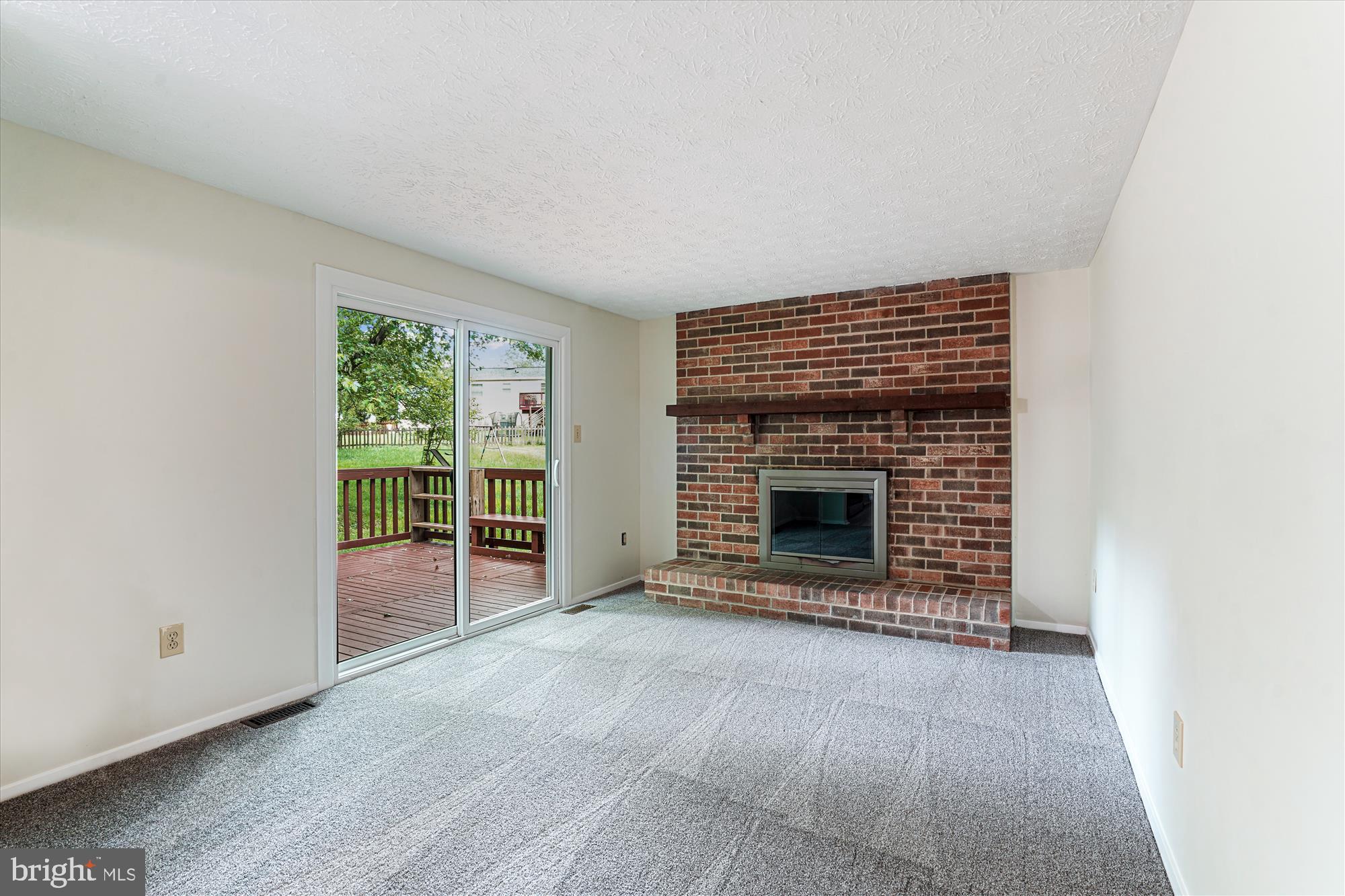 1221 Windmill Lane Silver Spring, MD 20905 - Photo 13 of 38 an empty room with floor to ceiling window and fireplace