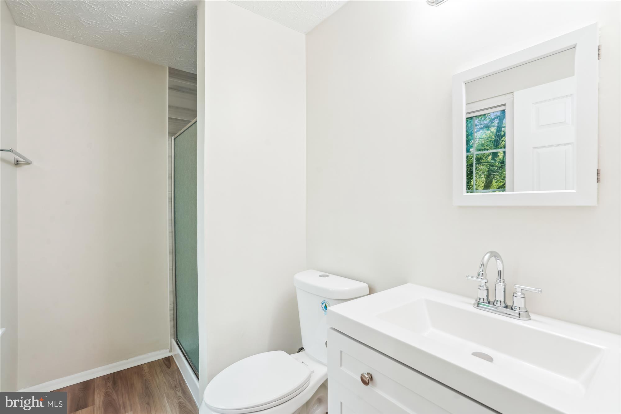 1221 Windmill Lane Silver Spring, MD 20905 - Photo 19 of 38 a bathroom with a sink a toilet and a window