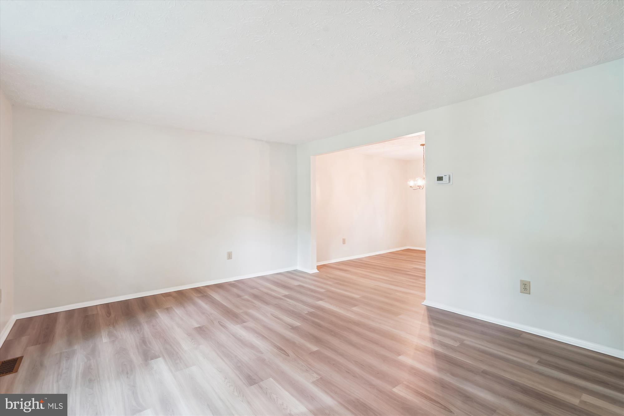 1221 Windmill Lane Silver Spring, MD 20905 - Photo 6 of 38 a view of an empty room and wooden floor