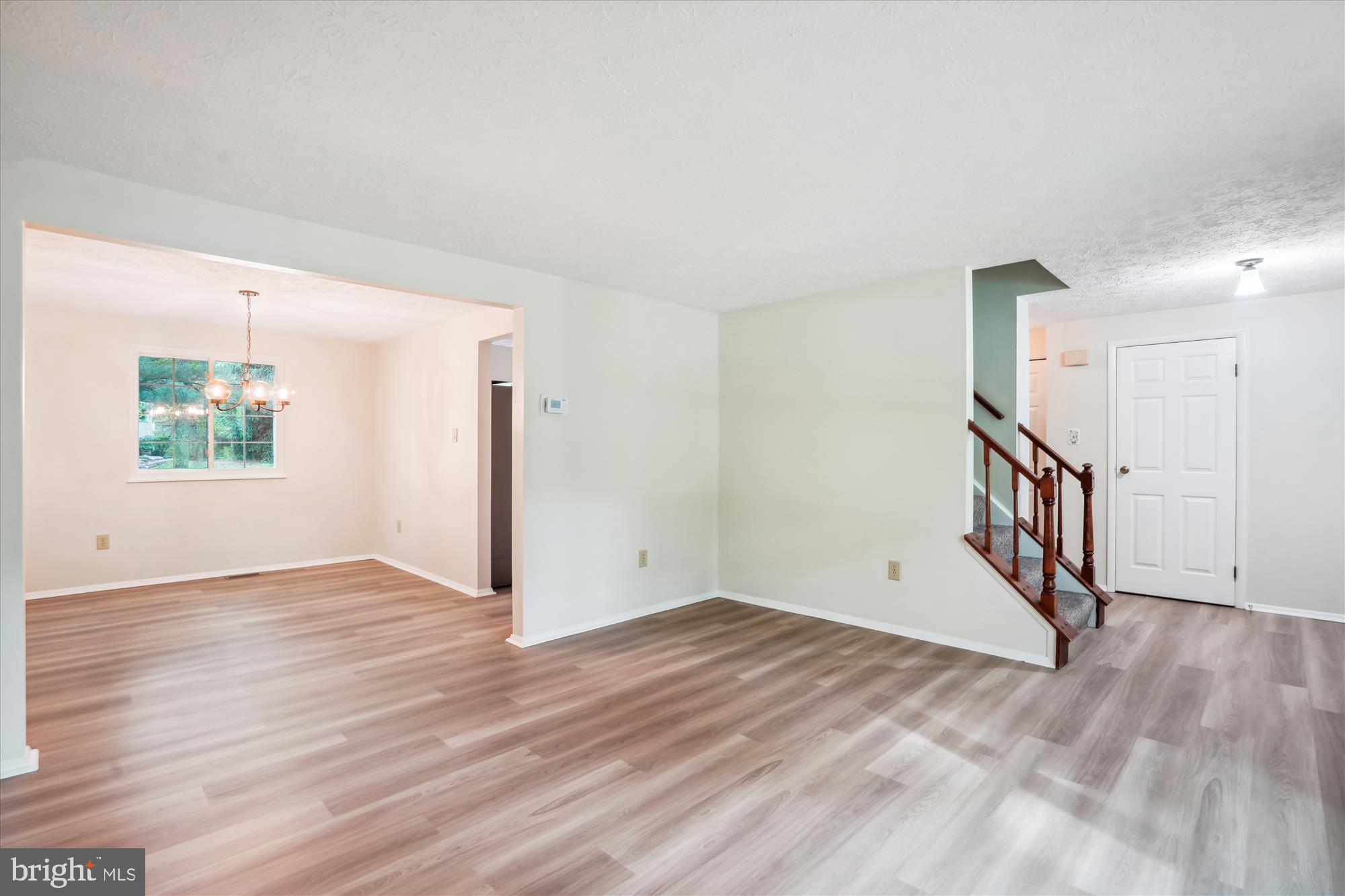 1221 Windmill Lane Silver Spring, MD 20905 - Photo 7 of 38 a view of an empty room with wooden floor and a window