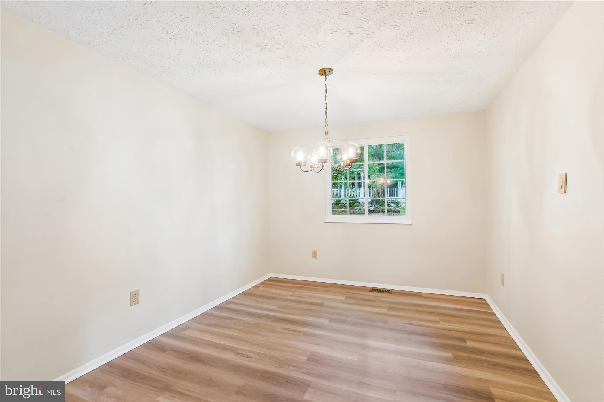 1221 Windmill Lane Silver Spring, MD 20905 - Photo 8 of 38 a view of empty room with wooden floor and fan