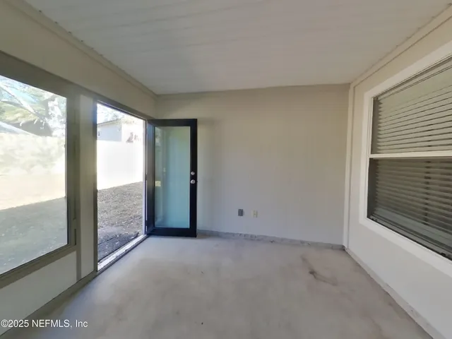 a view of an empty room with windows