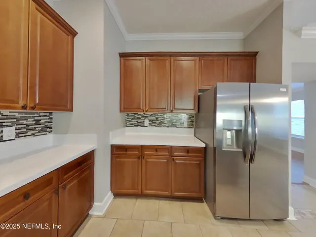 a kitchen with stainless steel appliances granite countertop a refrigerator and a stove