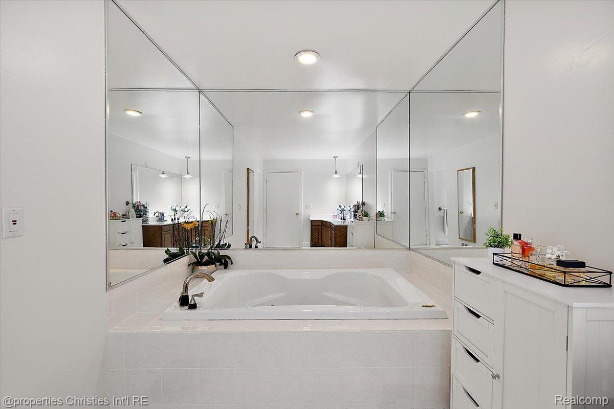 1830 Lone Pine Road Bloomfield Hills, MI 48302 - Photo 24 of 49 Bathroom with a bath, vanity, and recessed lighting