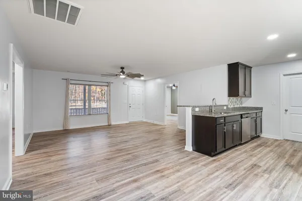 a view of a kitchen with a sink and refrigerator