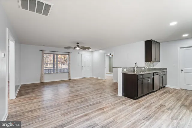 a view of a kitchen with a sink and refrigerator