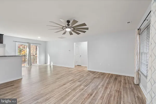 a view of kitchen with granite countertop cabinets and wooden floor
