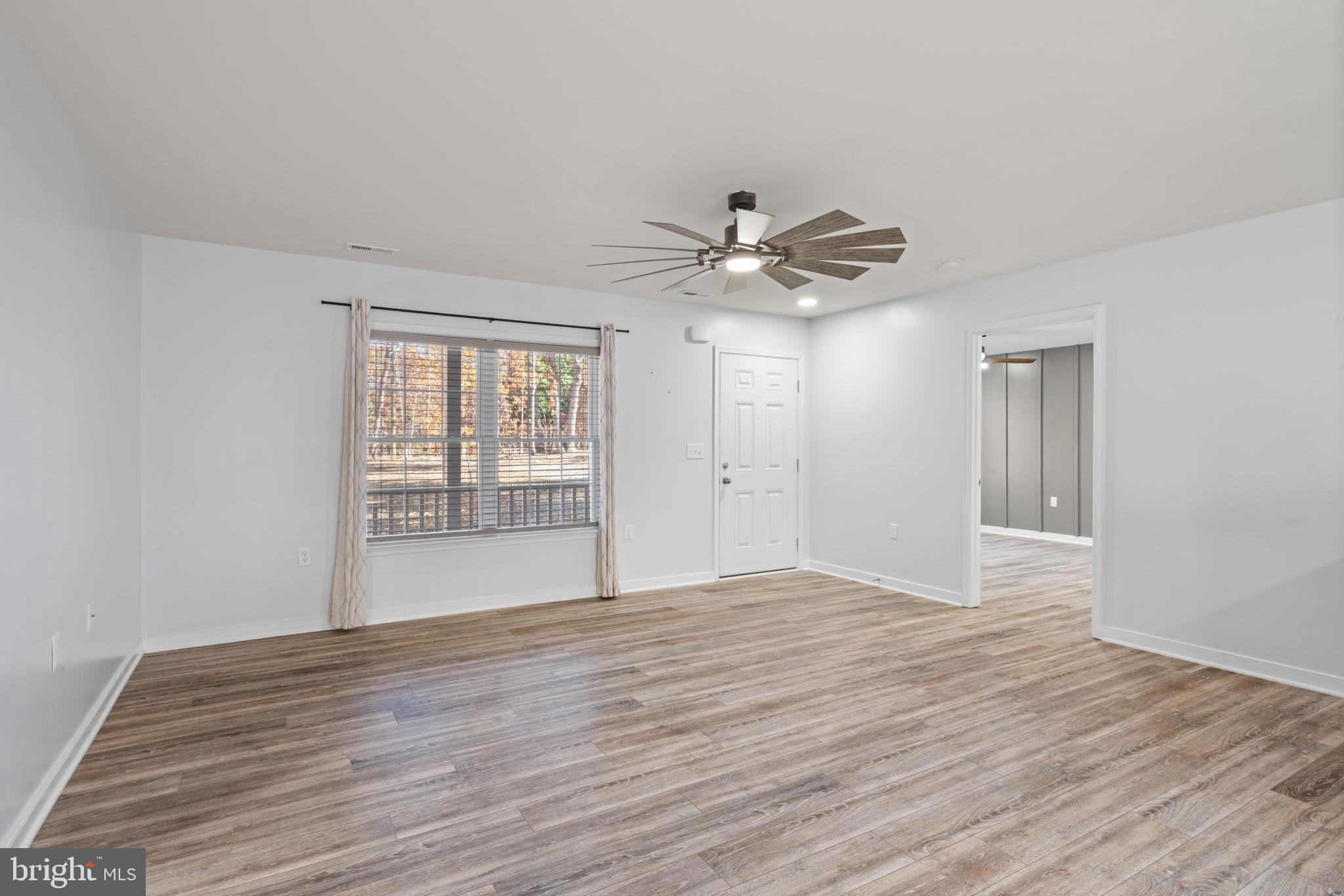 55 Cedar Circle Mineral, VA 23117 - Photo 19 of 44 a view of an empty room with a window and wooden floor