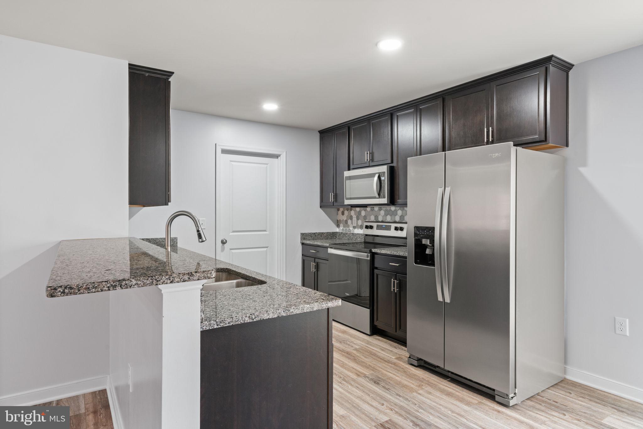 55 Cedar Circle Mineral, VA 23117 - Photo 20 of 44 a modern kitchen with stainless steel appliances granite countertop a refrigerator and a sink