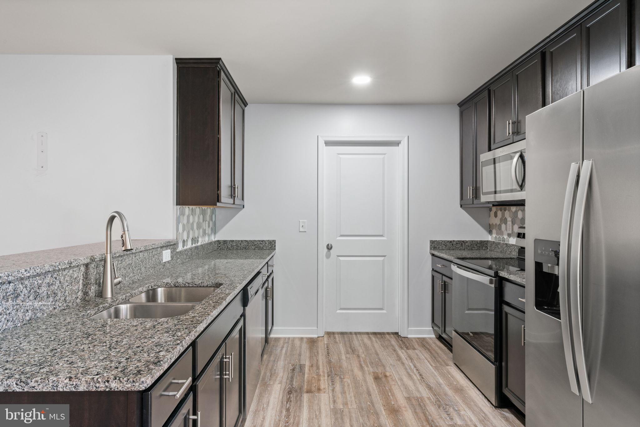 55 Cedar Circle Mineral, VA 23117 - Photo 21 of 44 a kitchen with kitchen island granite countertop a sink stove and refrigerator