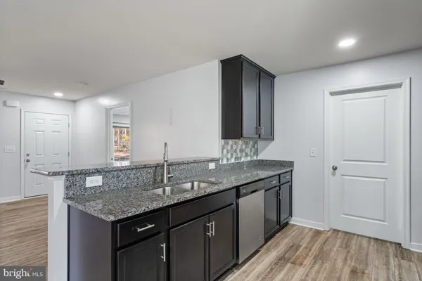 a kitchen with granite countertop stainless steel appliances and wooden cabinets