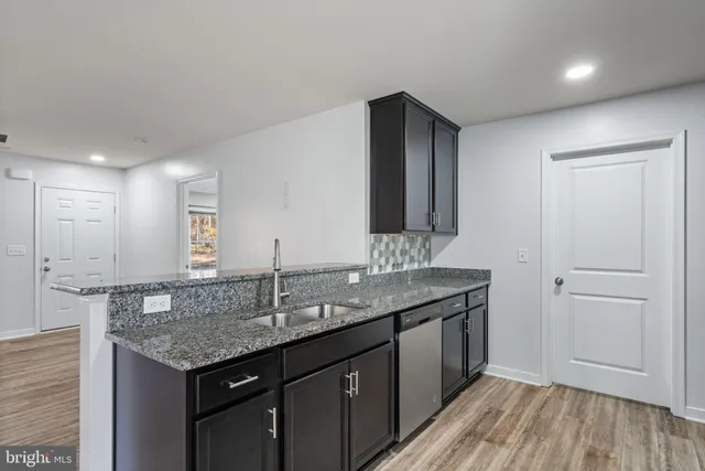 a kitchen with granite countertop stainless steel appliances and wooden cabinets